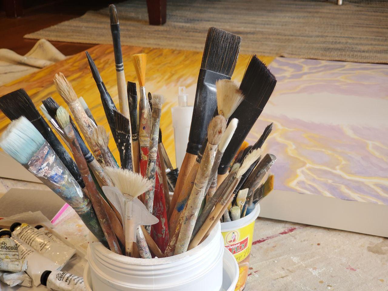 Before beginning a painting commission gathering brushes and materials