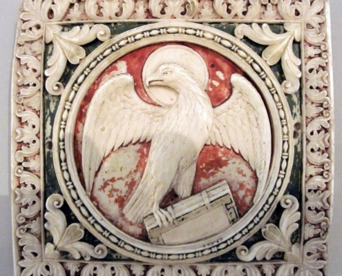 VA23Oct10_096-crop Carolingian ivory, Symbol of St John, V&A Museum. Photo: Johnbod, CC BY-SA 3.0, via Wikimedia Commons.